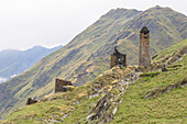 The ruins of the abandoned stone watch towers in the mountainside village of Girevi in the Tusheti National Park; Girevi, Kakheti, Georgia