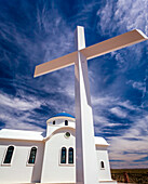 The impressive white cross and traditional Greek architecture of The Chapel of the Holy Prophet of Elias at St Anthony's Greek Orthodox Monastery; Florence, Arizona, United States of America
