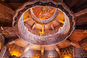 Interior of Desert View Watchtower, looking up at the false structured ceiling decorated with circular balconies, murals and petroglyph-style drawings, designed and built in the 1930's by Mary Colter to resemble an Ancestral Puebloan on the South Rim of the Grand Canyon; Grand Canyon National Park, Arizona, United States of America