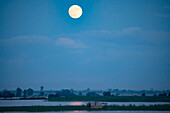 Full moon rising over the Ayeyarwady (Irrawaddy) River; Rural Jungle, Kachin, Myanmar (Burma)