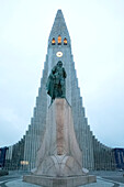 The Hallgrimskirkja, Lutheran cathedral with a statue of the first European to reach America, famous explorer Leif Erikson in front, which predates the church; Reykjavik, Capital Region, Iceland