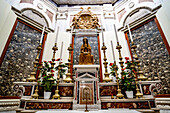 Chapel of the Martyrs with a statue of the Madonna and Child sitting above the altar and glass case crypts in the wall containing the remains of Otranto citizen martyrs inside the Cathedral of Saint Mary of the Announcement; Otranto, Puglia, Italy