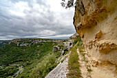 View of rock cliffs and plateau along the trails through the Gravina di Matera River and Park near Matera; Matera, Basilicata, Italy