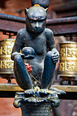Brass monkey figure in Kwa Bahal Golden Temple in the old city of Patan or Lalitpur built in the twelfth century by King Bhaskar Varman in the Kathmandu Valley; Patan (Lalitpur), Kathmandu Valley, Nepal