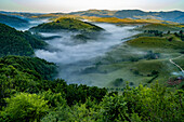 Morning mists in the valleys below Salciua in Sub Piatra of The Trascaului Mountains; Salciua, Sub Piatra, Transylvania, Romania