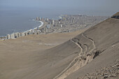 South part of the port city of Iquique with skyline and Cerro Dragon (Dragon Hill) the large, urban sand dune that overlooks the city; Iquique, Tarapaca, Chile