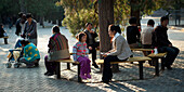 People Relaxing Outside The Temple Of Heaven; Beijing, China