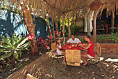 Tourist Family Sitting Together At Hotel California; Todos Santos Baja California Sur Mexico