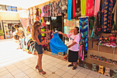 Women Looking At A Dress At A Downtown Shop; Todos Santos Baja California Sur Mexico