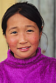 Mongolia, Young local woman in purple sweater; Ulaanbaatar