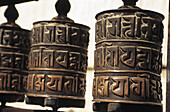 Nepal, Swayambhunath Temple; Kathmandu, Close-up of prayer wheels with carvings