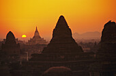 Burma (Myanmar), Bagan, Shwesandaw Paya, Temples Silhouetted Against Orange Sunset.