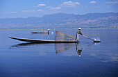 Burma (Myanmar), Inle Lake, Fishermen On Long Flat Boats, Reflections On Water.