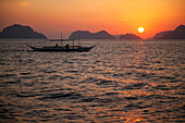 A Boat In The Water Off The Beach Of Corong Corong At Sunset; Corong Corong Bacuit Archipelago Palawan Philippines