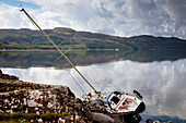 A Boat In The Water Leaning On It's Side Against The Shore; Argyll Scotland