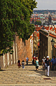 People Walking On The Steps Leading Down To The Old Town From The Royal Palace On Castle Hill; Prague Czech Republic