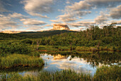 Mountains Reflecting In A Small Lake In The Early Morning Light In Waterton Lakes National Park; Alberta Canada