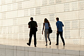 Three Adults Walking By Oslo Opera House; Oslo Norway