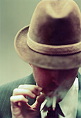 Head and Shoulders Portrait of Mid-Adult Man smoking Cigarette