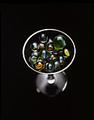 High Angle View of Cocktail Glass filled with Marbles