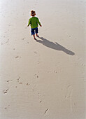 Young Boy climbing Lamppost