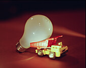 Light bulb leaning on toy dump truck