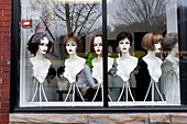 Wigs on Display in Store Window 