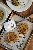 Salmon patties with potatoes, herbs and peas