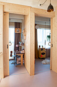 View through open sliding doors into two children's rooms