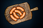 Knackwurst sausages on a wooden board