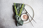 Minimalist table decoration with rosemary and pink Himalayan salt
