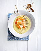 Broccoli and lentil soup with shrimp skewers