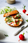 Bagel with lox, cucumber, dill, and cream cheese