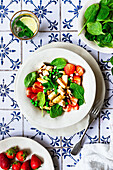 Strawberry and asparagus salad with spinach, mint, and almonds