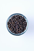 A bowl of black peppercorns