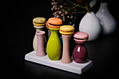 Macarons on colourful ceramic vases