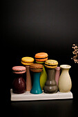 Macarons on colourful ceramic vases