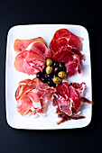 Different kinds of ham and pickled olives