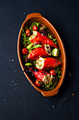 Tapas with stuffed pointed peppers, tomatoes, and pistachios