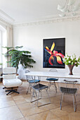 Bright dining area with modern art and designer chairs