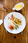 Crepes with white asparagus, ham and hollandaise sauce