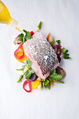 Sea bass with vegetables on parchment paper