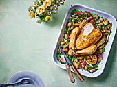 Spring roasted chicken on peas, potatoes, and garlic