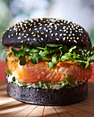 Salmon burger on black bun