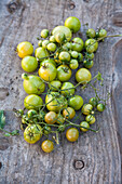 Green tomatoes on a wooden background