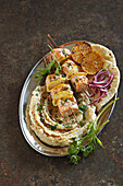 Spicy citrus salmon skewers with white bean puree