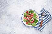 Summer salad with fresh strawberries, spinach, cream cheese and walnuts
