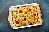Focaccia with green olives, olive oil, cherry tomatoes and rosemary