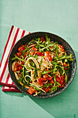 Spaghetti salad with tomatoes and arugula