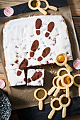 Cherry cake with footprint tracking motif with magnifying glass cookies